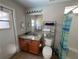 Granite counter tops, warm wood vanity and tile flooring add a touch of elegance to the cozy bathroom at 8457 Secret Key Cove, Kissimmee, FL 34747
