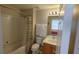 Cozy bathroom featuring a shower-tub combo, toilet, and vanity with a well-lit mirror at 8457 Secret Key Cove, Kissimmee, FL 34747