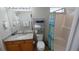 Bright bathroom with granite countertops, a toilet, and a shower with blue and white accents at 8457 Secret Key Cove, Kissimmee, FL 34747