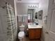 Cozy bathroom featuring a shower-tub combo, toilet, and vanity with a well-lit mirror at 8457 Secret Key Cove, Kissimmee, FL 34747