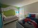 A shared bedroom with two beds, fun decorations, and a spacious closet at 8457 Secret Key Cove, Kissimmee, FL 34747