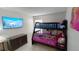 Bedroom featuring a bunk bed, TV, and built in storage at 8457 Secret Key Cove, Kissimmee, FL 34747