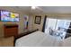 Bedroom with a large bed, TV, and a sliding glass door that opens to a patio at 8457 Secret Key Cove, Kissimmee, FL 34747