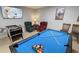 Spacious game room featuring a pool table, foosball table, comfy chairs, and a large TV at 8457 Secret Key Cove, Kissimmee, FL 34747