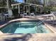 Relaxing community hot tub is surrounded by lounge chairs and lush landscaping at 8457 Secret Key Cove, Kissimmee, FL 34747