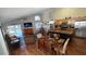 Open floor plan showcasing a living room with a dining area, modern kitchen, and access to a screened pool area at 8457 Secret Key Cove, Kissimmee, FL 34747