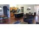 Well-lit living space with wood flooring, an open kitchen, cozy seating and an inviting atmosphere at 8457 Secret Key Cove, Kissimmee, FL 34747