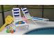 Two lounge chairs with pool toys sit next to a sparkling pool, perfect for relaxation and fun at 8457 Secret Key Cove, Kissimmee, FL 34747