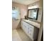 Bathroom featuring a vanity with drawers and a large mirror with a black frame at 102 Tangelo Cv, Leesburg, FL 34748