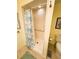 Bathroom featuring a tile shower and toilet in a yellow painted room at 102 Tangelo Cv, Leesburg, FL 34748