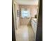 Bathroom featuring a white vanity with drawers and a window with bright, natural light at 102 Tangelo Cv, Leesburg, FL 34748