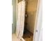 Bathroom featuring a tile shower with a floral shower curtain and hand rails at 102 Tangelo Cv, Leesburg, FL 34748