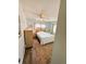 Bright bedroom with light-blue walls, a ceiling fan, a wood bed frame, and wood laminate flooring at 102 Tangelo Cv, Leesburg, FL 34748