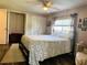 Bedroom with a bed, a ceiling fan, a carpet and closet storage at 102 Tangelo Cv, Leesburg, FL 34748