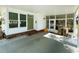Covered carport area with view of front door and screened entrance at 102 Tangelo Cv, Leesburg, FL 34748