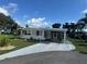 Inviting home with a carport, well-manicured lawn, and curb appeal at 102 Tangelo Cv, Leesburg, FL 34748