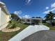 Charming home features covered parking, mature landscaping, and inviting curb appeal at 102 Tangelo Cv, Leesburg, FL 34748
