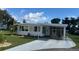 Attractive home with covered parking, pristine landscaping, and charming curb appeal at 102 Tangelo Cv, Leesburg, FL 34748