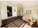 Inviting Florida room featuring neutral walls and a comfortable armchair at 102 Tangelo Cv, Leesburg, FL 34748