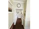 Hallway with neutral paint and a large decorative clock at 102 Tangelo Cv, Leesburg, FL 34748