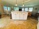 Open kitchen with an island featuring granite countertops and adjacent dining area at 102 Tangelo Cv, Leesburg, FL 34748