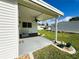 Covered patio with a ceiling fan, decorative planters, and ample space for outdoor entertaining at 102 Tangelo Cv, Leesburg, FL 34748