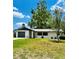 Charming single-story home featuring a well-maintained lawn, garage, and serene landscaping at 10529 Se 50Th Ave, Belleview, FL 34420