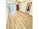Bright living room features light wood flooring and sliding glass doors to an outdoor area at 10529 Se 50Th Ave, Belleview, FL 34420