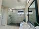 This bathroom features a glass shower with gray tiling, a built-in shower seat, and modern fixtures at 10640 Vista Del Sol Cir, Clermont, FL 34711