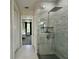 This bathroom showcases a glass shower and convenient access to the main bedroom at 10640 Vista Del Sol Cir, Clermont, FL 34711