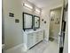 This bathroom features a dual-sink vanity with stylish mirrors and a separate toilet area at 10640 Vista Del Sol Cir, Clermont, FL 34711