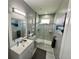 Modern bathroom featuring a marble tiled shower, vanity with sink, sleek light fixture, and soothing gray walls at 10640 Vista Del Sol Cir, Clermont, FL 34711