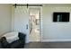 This bathroom features a large, frameless shower behind a white barn door at 10640 Vista Del Sol Cir, Clermont, FL 34711