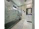 This bathroom features a large frameless shower with a built-in seat and a gray vanity at 10640 Vista Del Sol Cir, Clermont, FL 34711