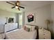 This comfy bedroom features a dresser, modern lighting, and big windows at 10640 Vista Del Sol Cir, Clermont, FL 34711