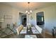 The dining room features a wood table, seating for six, a modern chandelier, and views to other rooms at 10640 Vista Del Sol Cir, Clermont, FL 34711