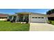 Charming single-story home featuring a well-manicured lawn and a two-car garage at 10640 Vista Del Sol Cir, Clermont, FL 34711