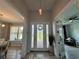 Bright foyer with decorative glass front door, views to the dining, and french doors leading to a sitting room at 10640 Vista Del Sol Cir, Clermont, FL 34711