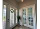 Inviting foyer with decorative glass front door and glass french doors to the right at 10640 Vista Del Sol Cir, Clermont, FL 34711