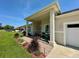 Inviting covered front porch featuring brick flooring and stylish landscaping at 10640 Vista Del Sol Cir, Clermont, FL 34711