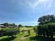 Scenic view of a golf course with rolling greens and clear blue skies, offering a picturesque and serene environment at 10640 Vista Del Sol Cir, Clermont, FL 34711