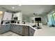 Modern kitchen features gray and white cabinetry, stainless steel appliances, and spacious quartz countertops at 10640 Vista Del Sol Cir, Clermont, FL 34711