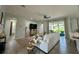 Open-concept living area with a white sofa, large TV, and sliding glass doors leading to the backyard at 10640 Vista Del Sol Cir, Clermont, FL 34711