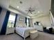 Spacious main bedroom featuring a tray ceiling, large windows, and elegant decor at 10640 Vista Del Sol Cir, Clermont, FL 34711