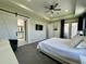 This main bedroom features patio access, barn door to bathroom, and sleek ceiling fan at 10640 Vista Del Sol Cir, Clermont, FL 34711
