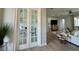 View into home office through french doors, seamlessly connected to the living room at 10640 Vista Del Sol Cir, Clermont, FL 34711