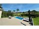 Backyard view featuring a rectangular pool, patio area with lounge chairs, and lush green landscaping at 10640 Vista Del Sol Cir, Clermont, FL 34711