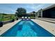 Inviting pool with lounge chairs and a view of lush greenery, perfect for relaxing and entertaining guests at 10640 Vista Del Sol Cir, Clermont, FL 34711