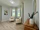 Bright sitting area with a bay window, comfortable chairs, and serene decor at 10640 Vista Del Sol Cir, Clermont, FL 34711