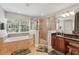 Bathroom showcasing a tub, shower and cherry cabinets at 1085 Harmony Ln, Clermont, FL 34711